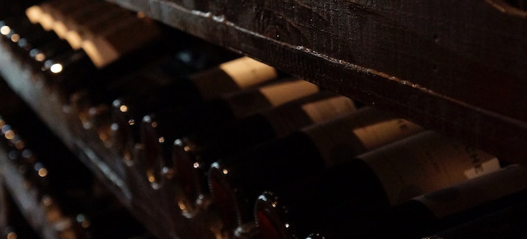 bottles on the rack prepared for moving a wine collection