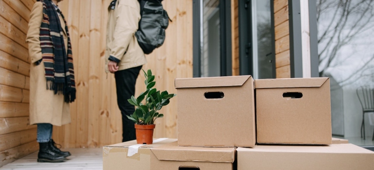 Picture of a couple talking beside a pile of boxes