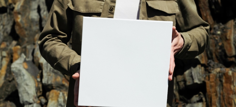 Picture of a man carrying a white box 