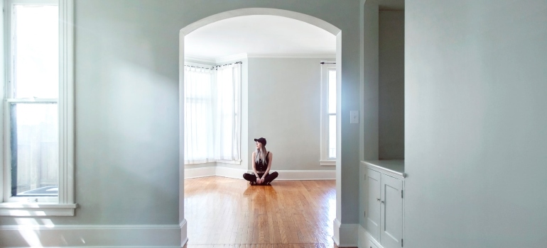 A girl sitting in an empty home. 