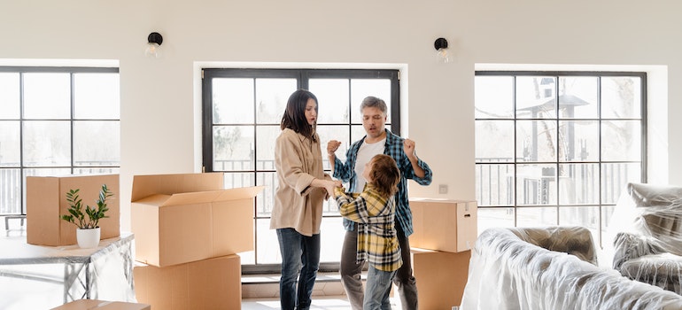 Happy family in new home with moving boxes