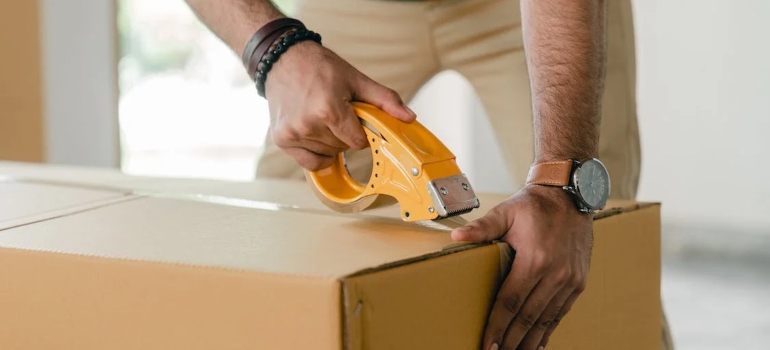 a man cutting up a box