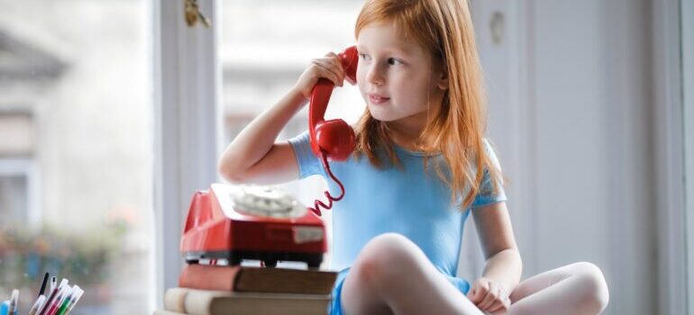 A little girl talking on the phone