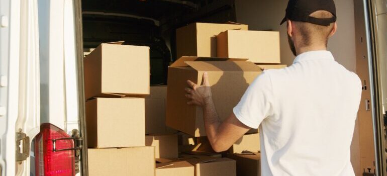 A guy loading the box in the van