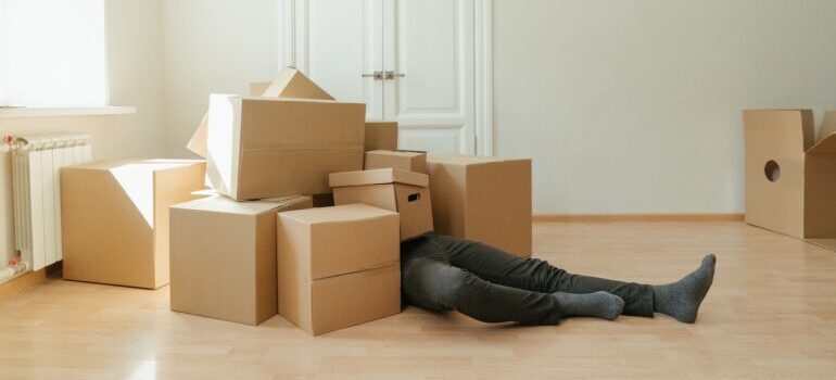 Man drowning in moving boxes