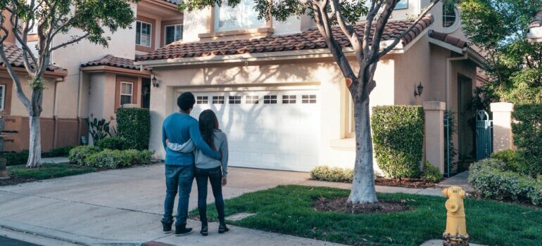 A couple in front of their new home