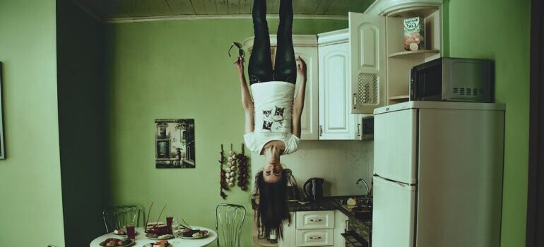 A girl standing in the room upside down