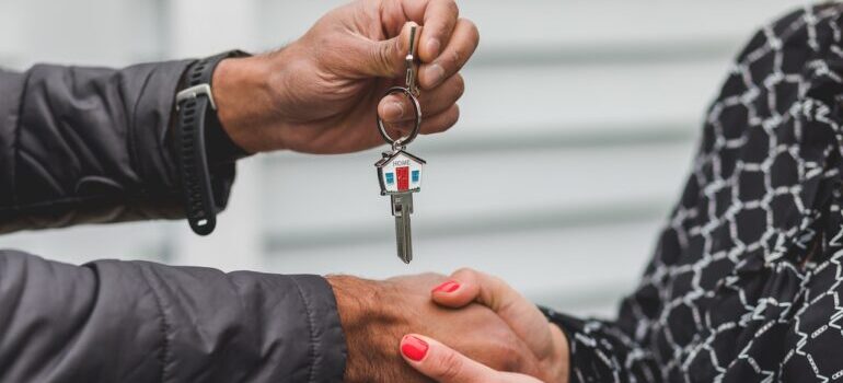 People exchanging house keys