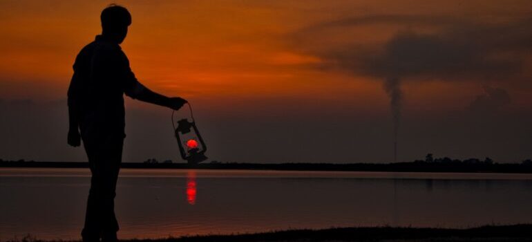 A man by the river at sunset