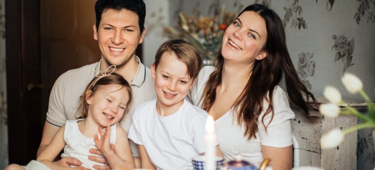 Family posing for a photo during a meal