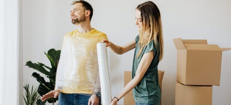 A couple joking around while packing