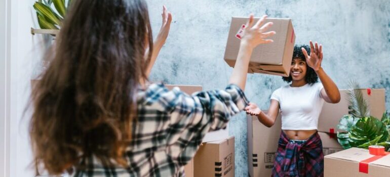 Girls throwing boxes