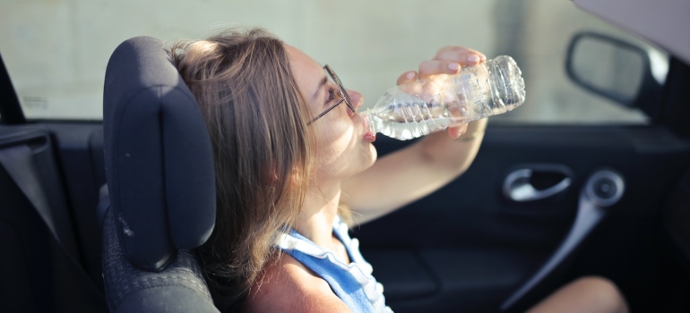 A person drinking water after reading about how to survive the DC summer heat