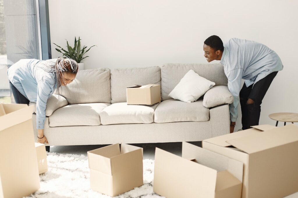 a couple lifting a couch