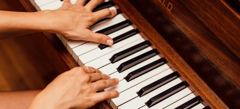 a person playing a piano before they decide to move a piano without professional movers