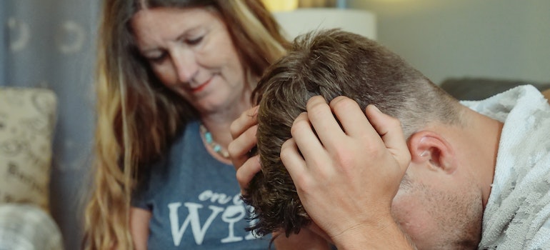 A woman comforting a man who is in emotional distress which if neglected can be a common moving mistake you should avoid.