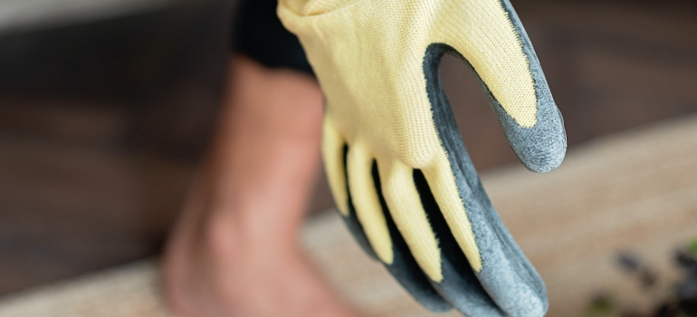 a person holding heavy duty gloves