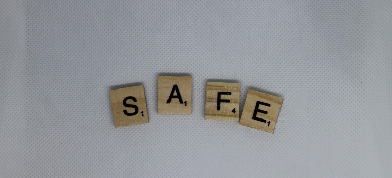scrabble tiles spelling the word "safe"