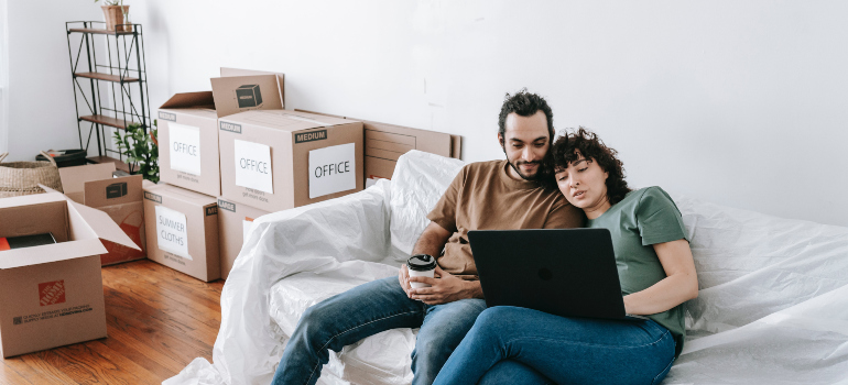 a couple exploring Virginia moving costs and options on their laptop