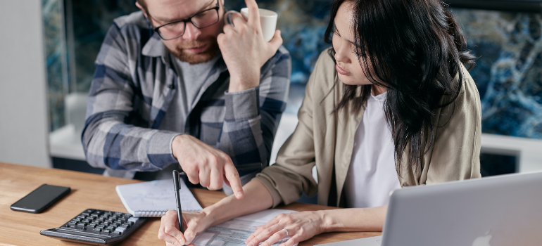 man and woman calculating property taxes in Arlington