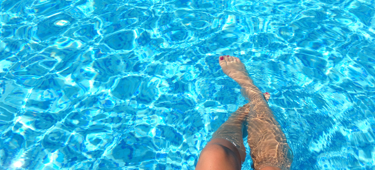 Woman's legs in a swimming pool 