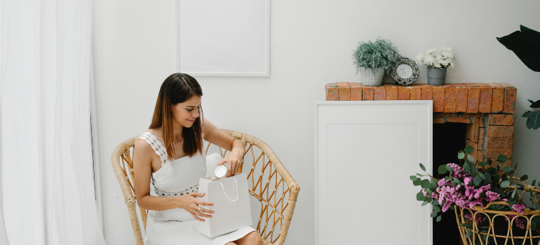 a woman happily opening a goodie-bag