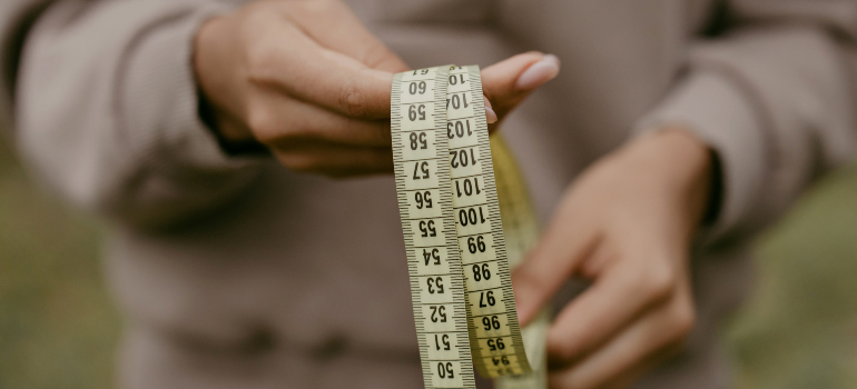 a person holding a measuring tape