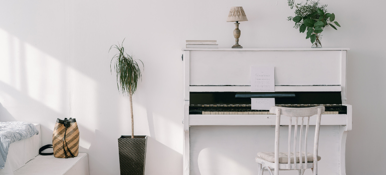 a white piano in an elegant room