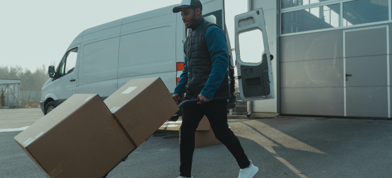 a person using a furniture dolly which is a good idea according to the tips for packing and moving bulky 