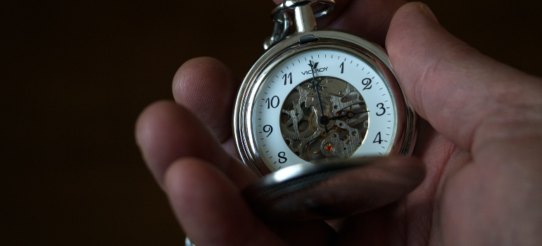 a person holding a pocket watch