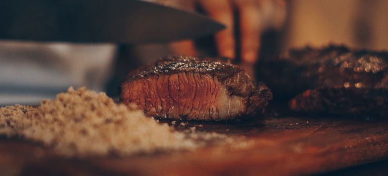 a person cutting a tasty-looking steake