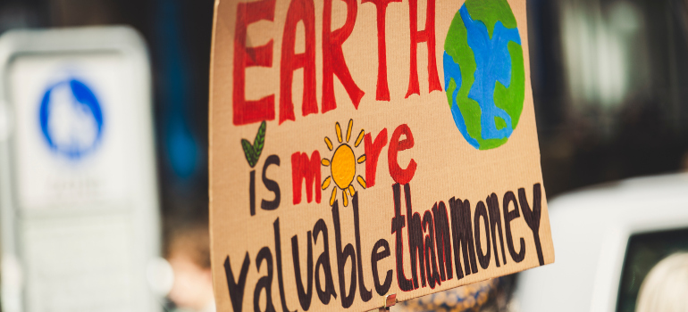 a poster that says "Earth is more valuable than money"