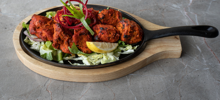 an Indian dish arranged on a black pan