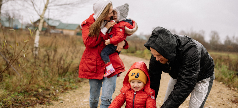 a family of four exploring their new hometown in the rain