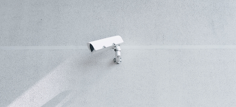 a white security camera on the wall