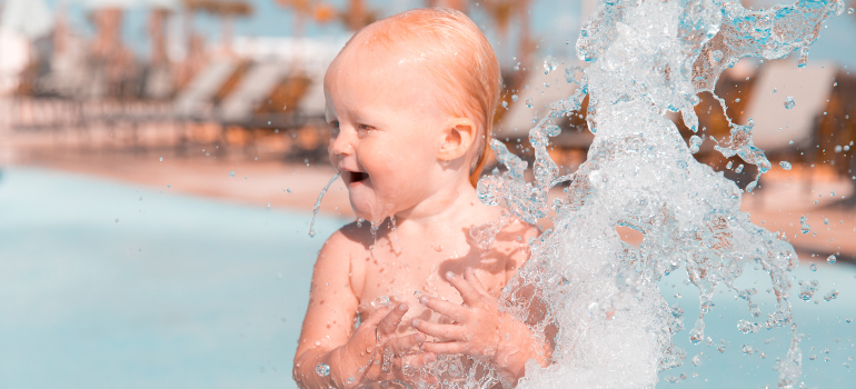 a baby bathing in a waterpark pool 