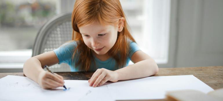 a child writing something in a notebook