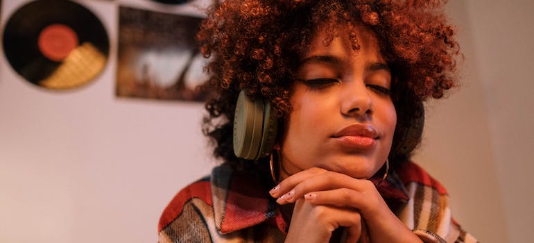 a woman using headphones to listen to music