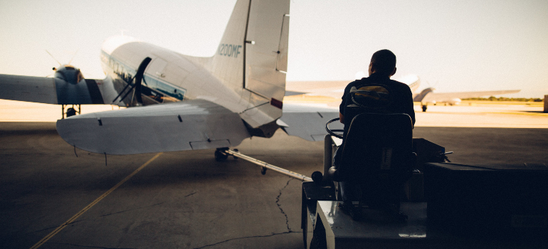 a worker at the airport observing a plane 