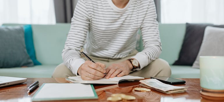 a man writing something down on a piece of paper