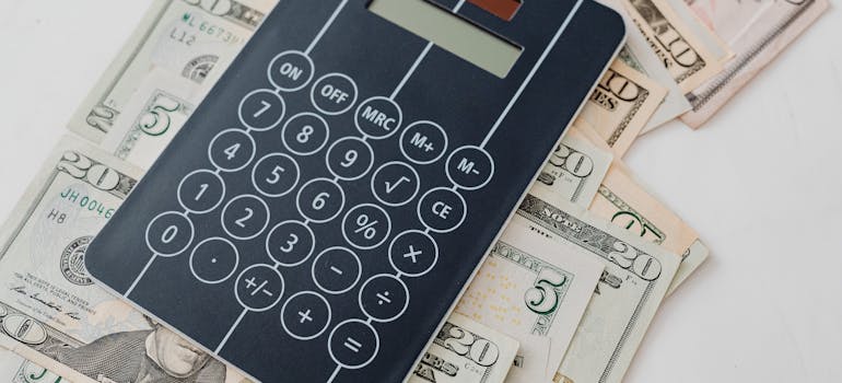a calculator on top of dollar bills