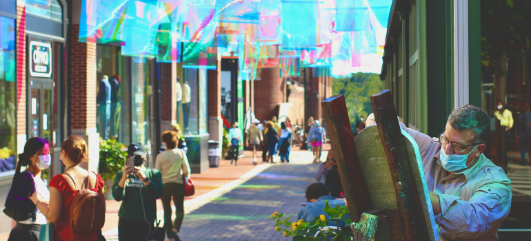 a colorful street in Georgetown, in Washington DC, where a street artist is drawing