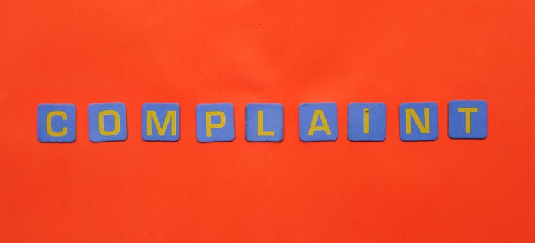 word "complaint" on a red surface