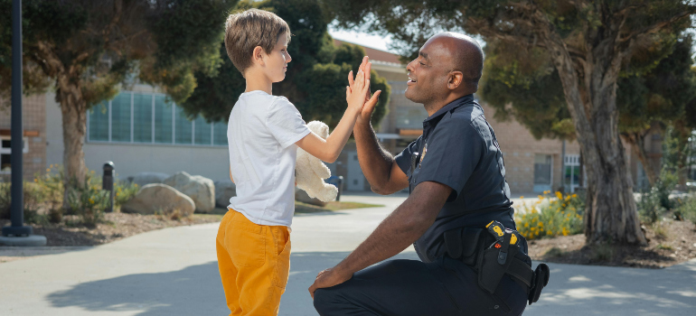a police officer saying hello to a little boy