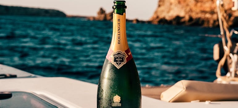 a bottle of champagne on a yacht deck