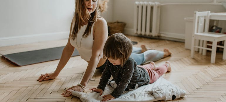 a mother and her daughter doing yoga together after moving to Arlington VA with a newborn