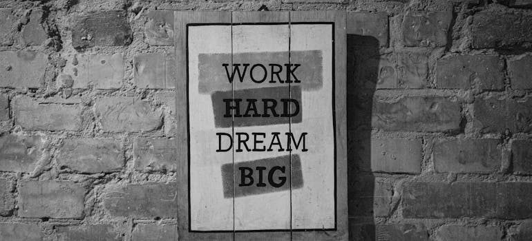 a framed quote "work hard, dream big"