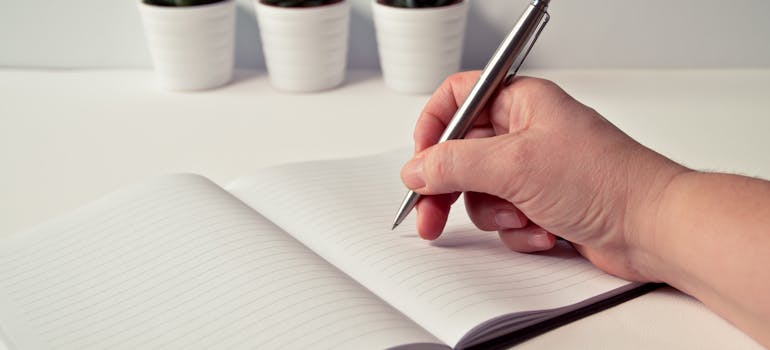 a man writing something in his planner