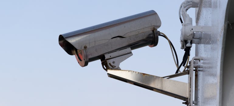 a surveillance camera, mounted on some wall