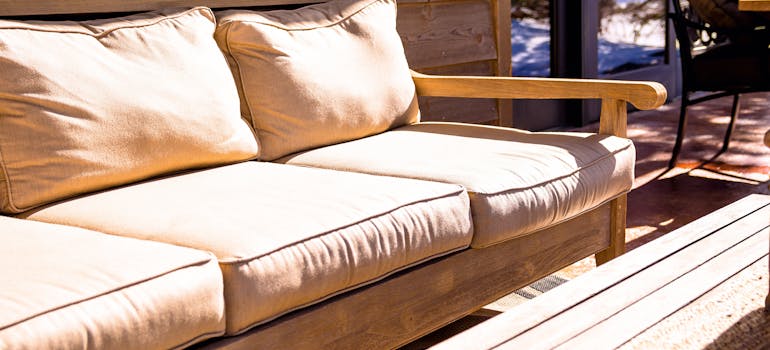 an outdoor sofa, and a wooden table